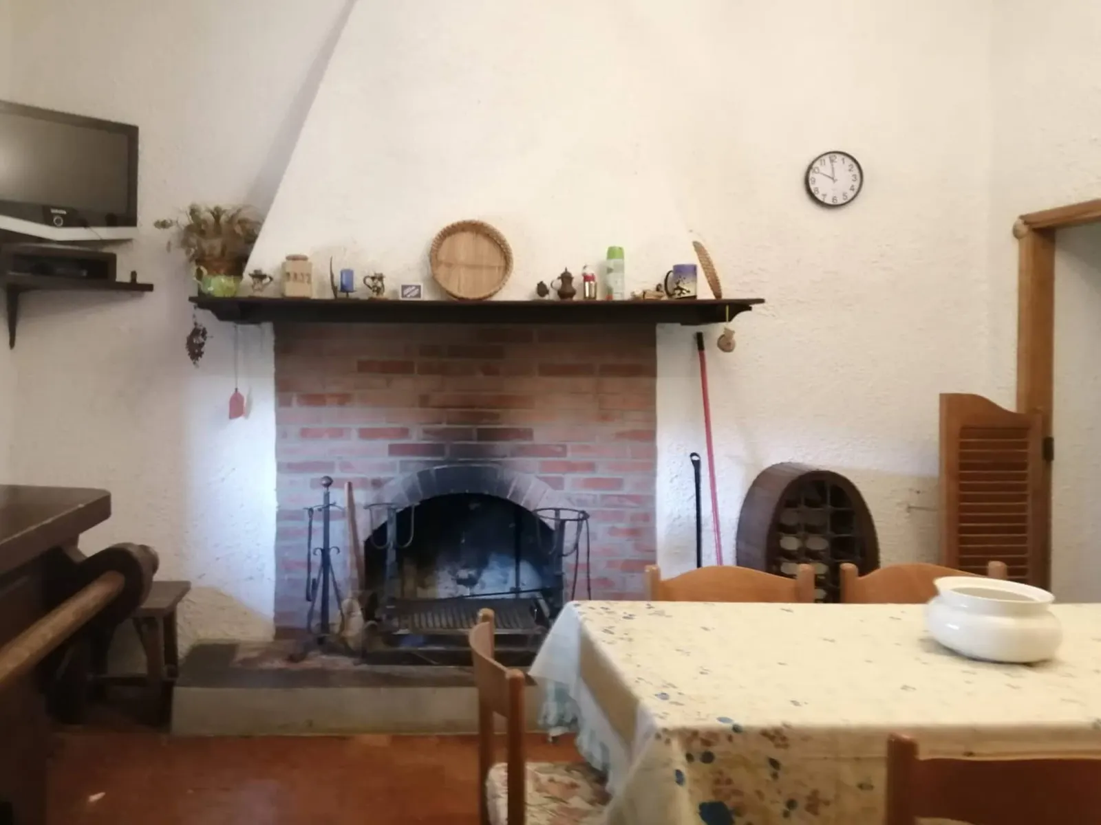 The dining room with the large wood-burning fireplace