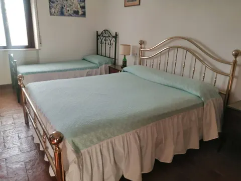 Bedroom with a brass double bed and a single bed