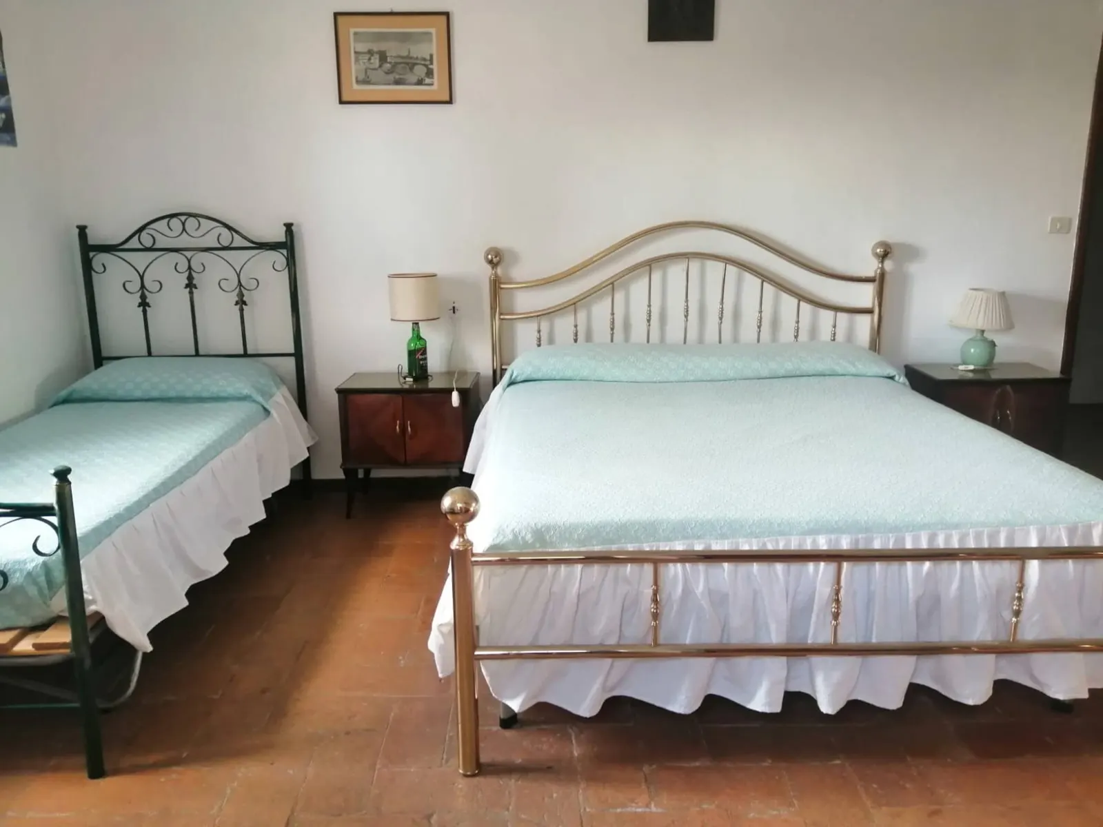 Bedroom with a double bed and an iron single bed
