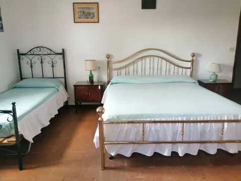 Bedroom with a double bed and an iron single bed