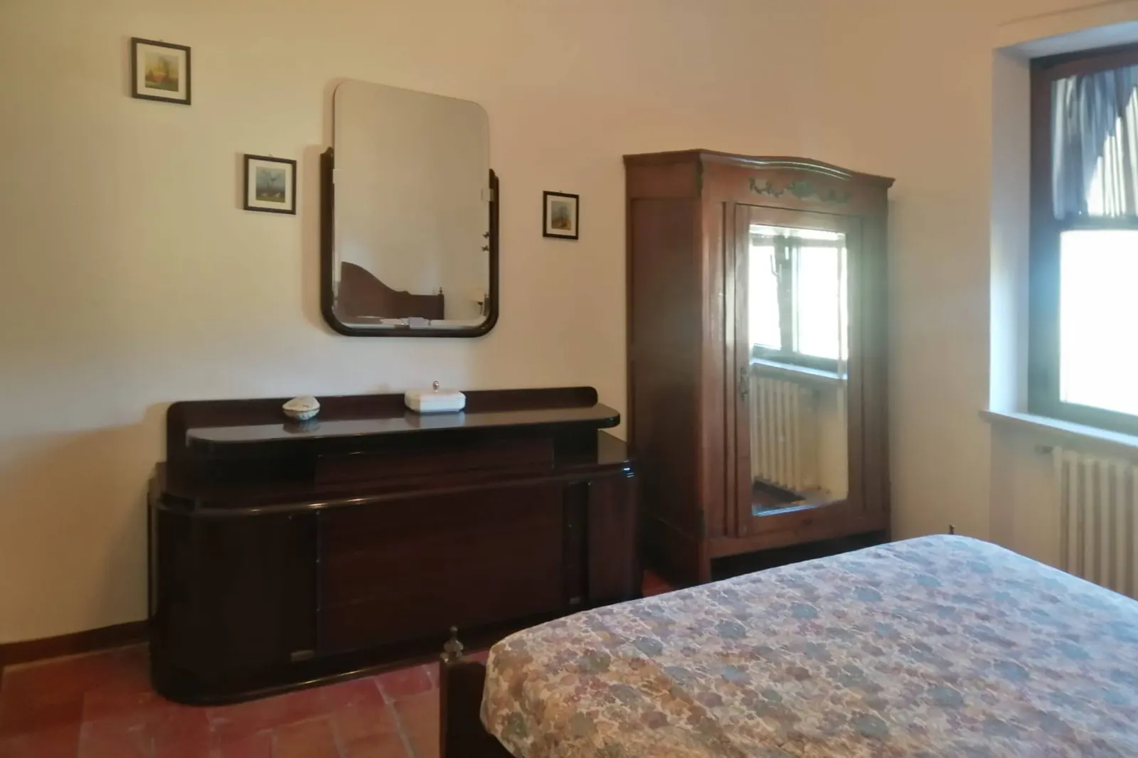 Bedroom with a chest of drawers and mirror