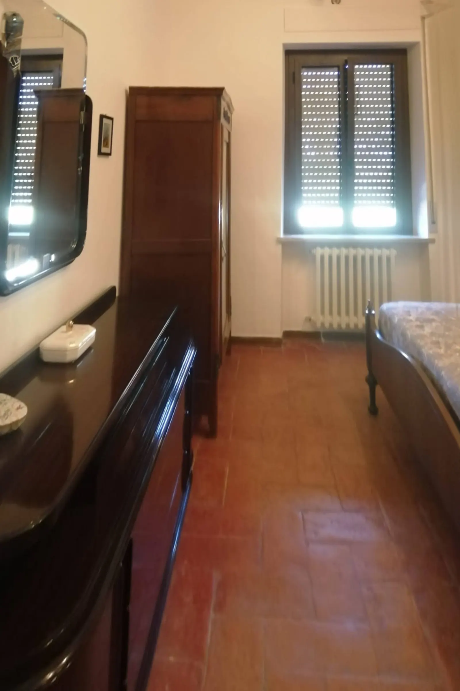 Bedroom seen from the door, with wardrobe and window