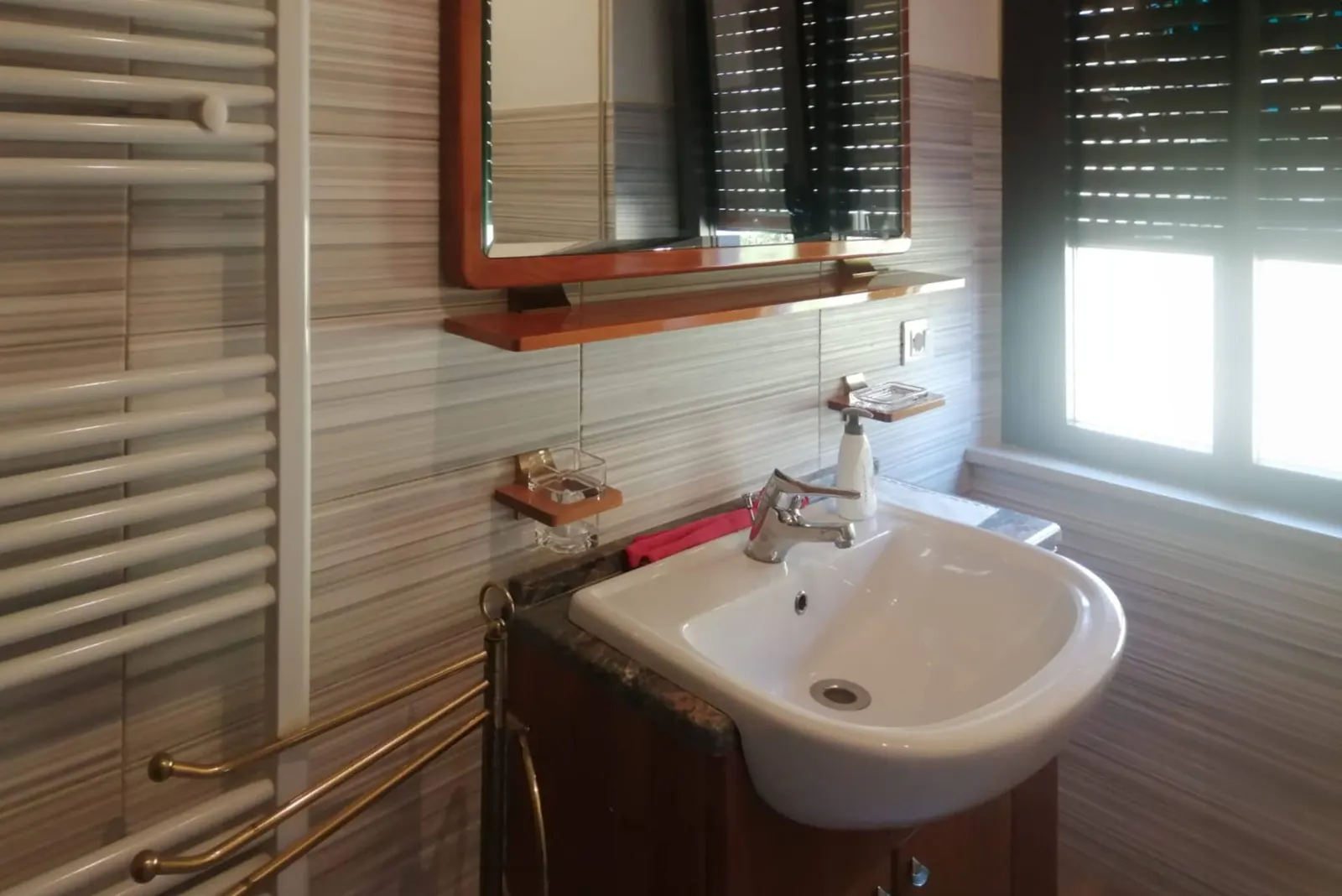 Washbasin and heated towel rail in the second bathroom