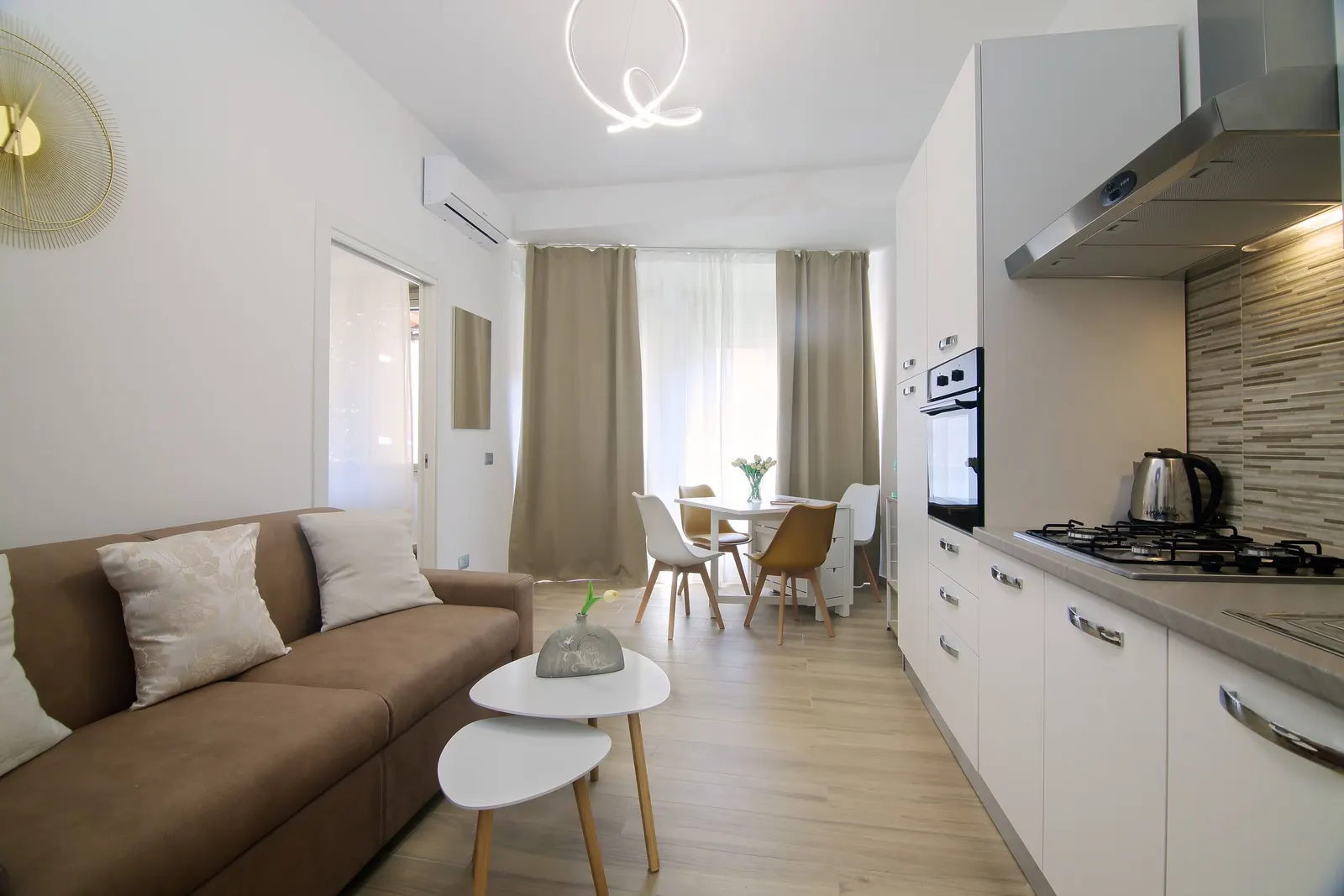 The living room with sofa, coffee tables and kitchenette
