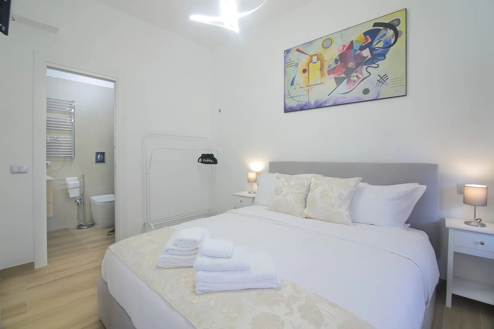 Double bedroom with its en-suite bathroom, seen through the open door