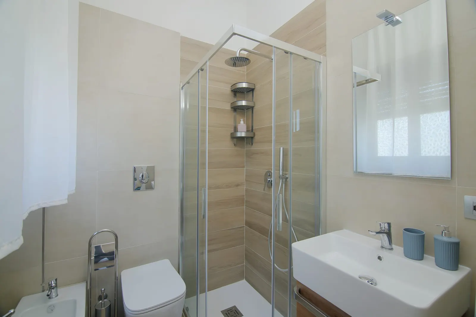 Bathroom with glass shower, washbasin and fittings