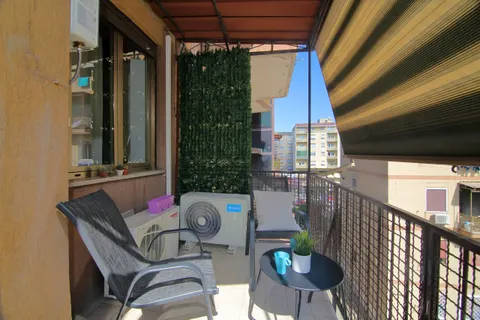 The living-room balcony with chairs and a small table