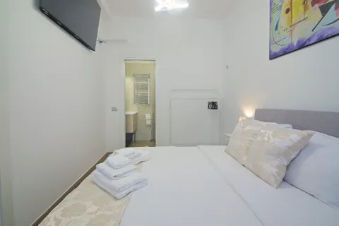 Bedroom with en-suite bathroom: the bed and the bathroom door