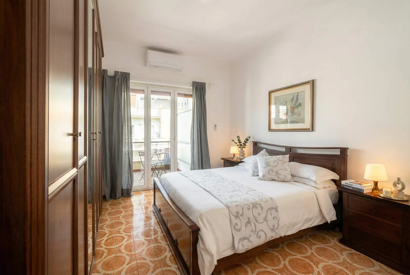 The romantic bedroom: wooden double bed and French window onto the balcony