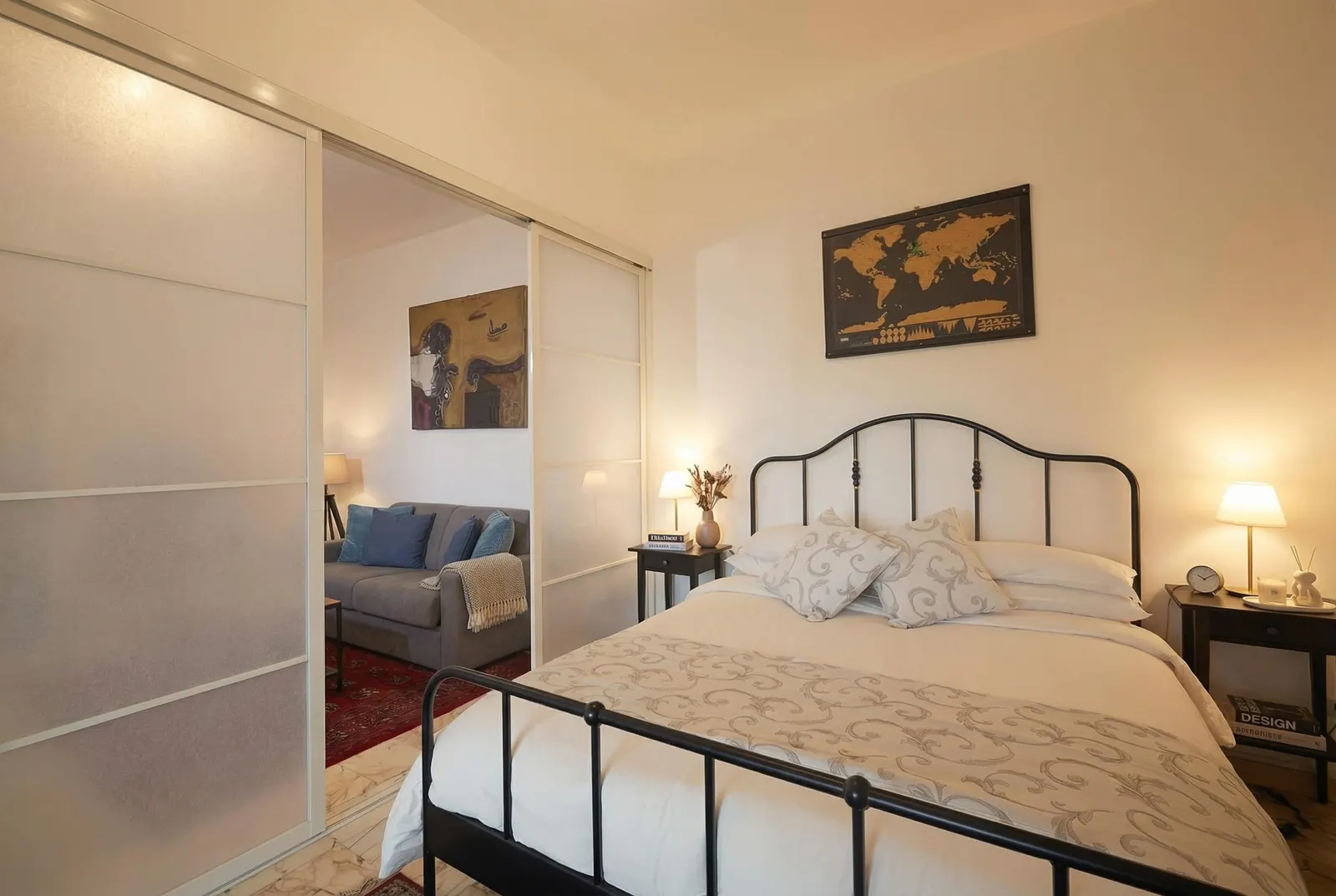 The suite with the partition open: the bed and, beyond it, the sitting area