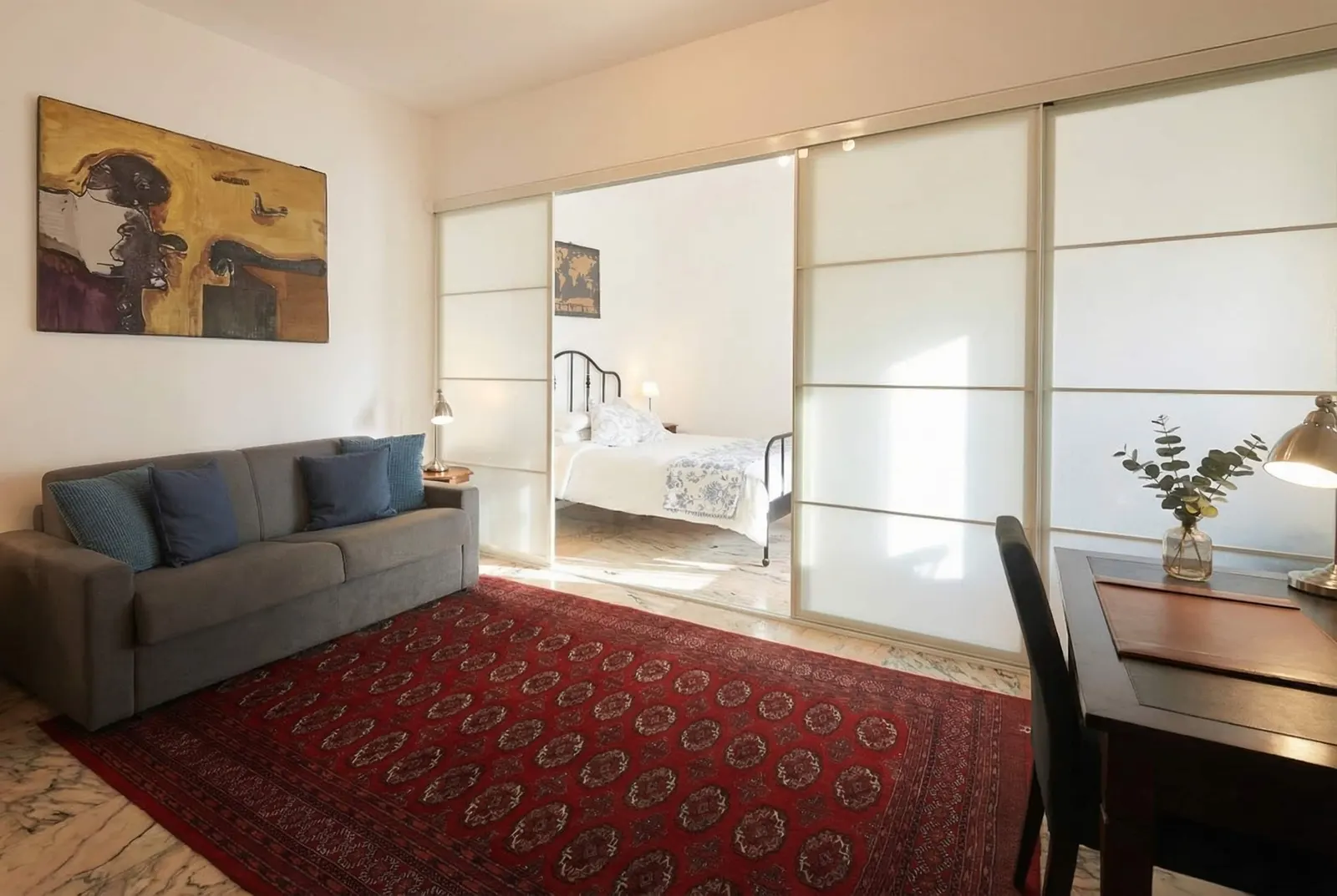 The suite's sitting area with sofa and Persian rug