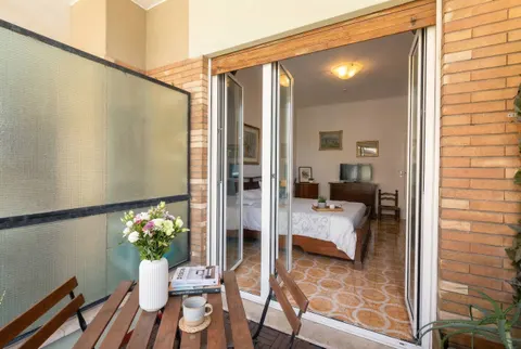 The romantic bedroom's balcony, with a small wooden table and chairs