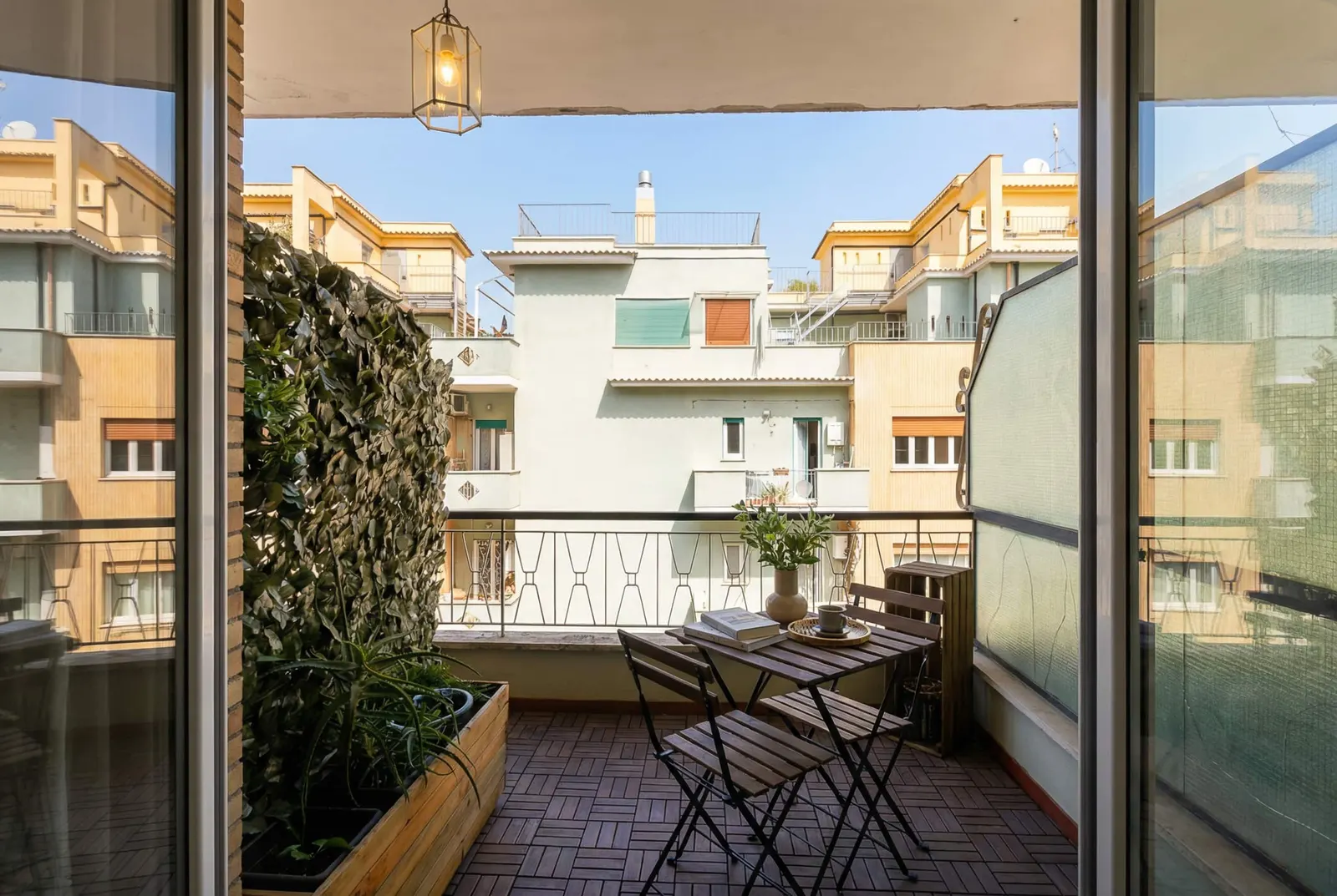 From the romantic bedroom out to the balcony and the buildings beyond