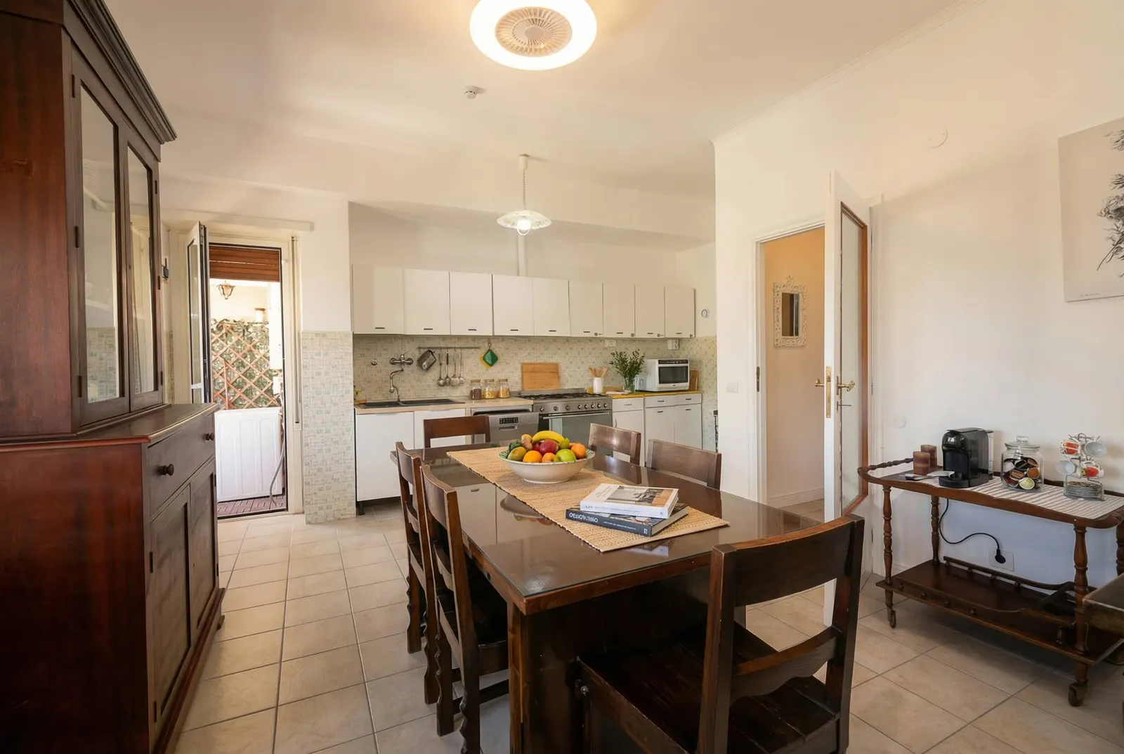 The dining table with the kitchenette behind