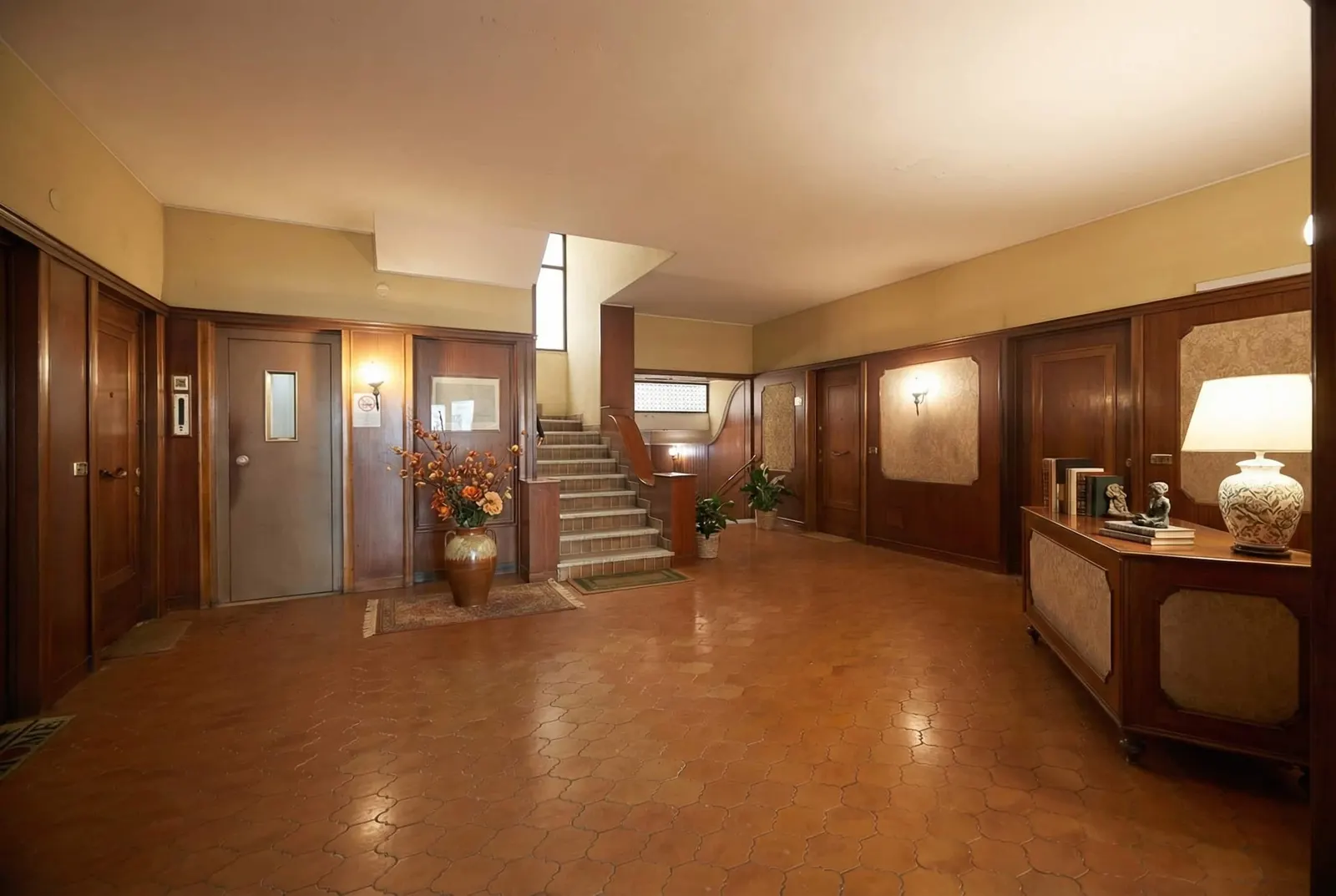 The building's lobby with the stairs and the lift